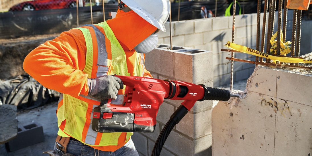 Construction worker using a TE 60-A36 Cordless combihammer  with Active Torque Control (ATC) to help prevent kickback