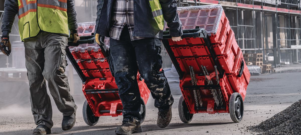 Cropped application picture of two workers using Prokit Modular Storage System in the jobsite