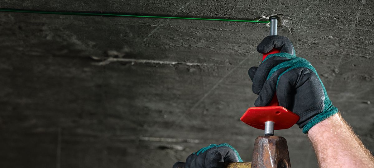 Cropped application picture of a worker using a HSD-G drop-in anchor setting tool to install HDI-TZ anchors. Produced by HNA. Dallas, TX, March 8, 2024.